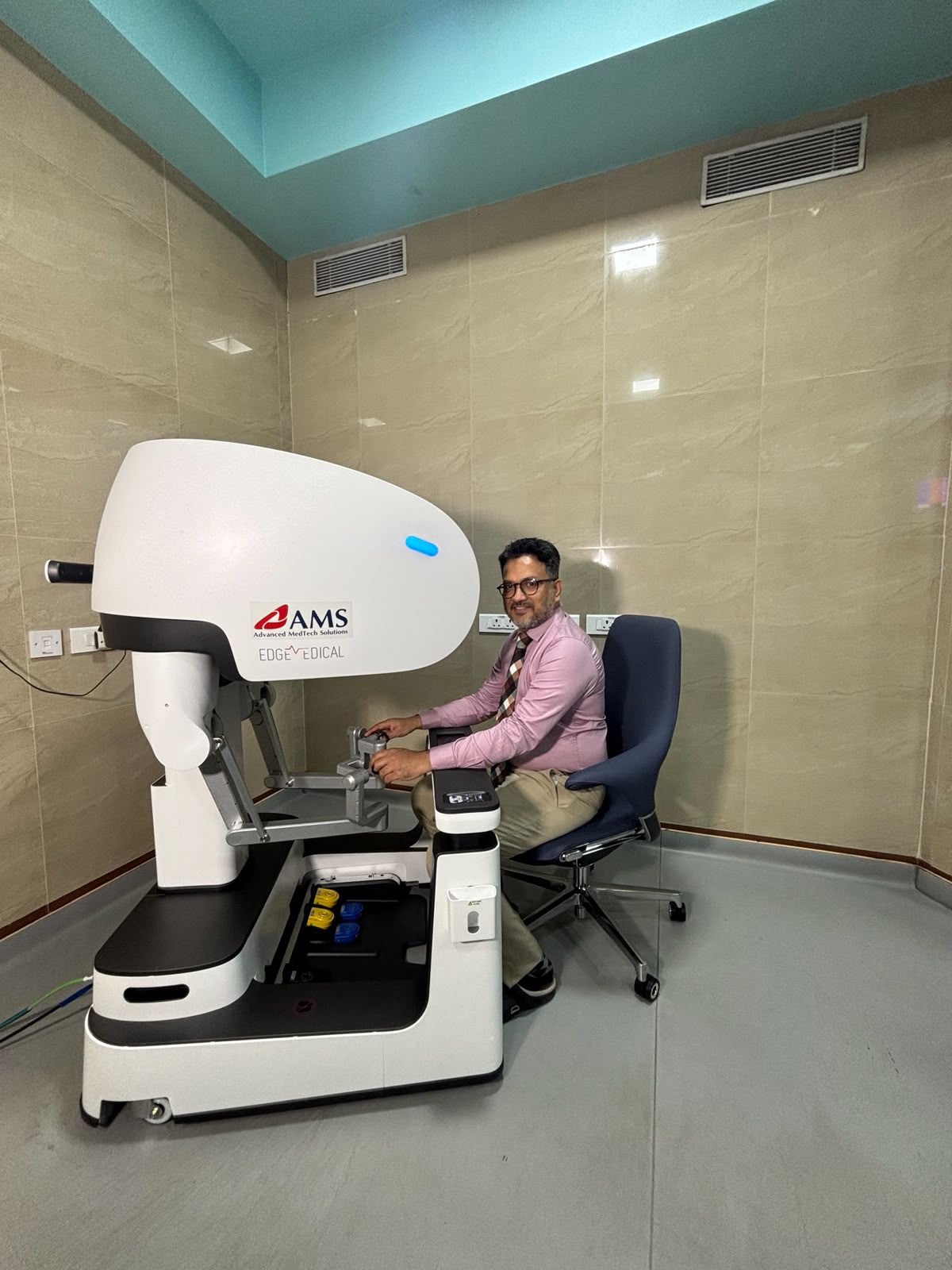 Dr. Rohan Shetty, surgical oncologist, at a robotic surgery console in Mangalore